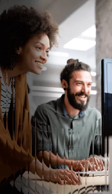 A man at a woman collaborating at a work station
