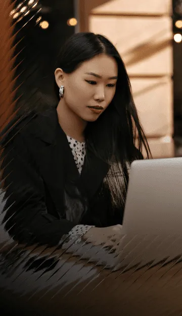 A woman on her laptop, looking for the contact page