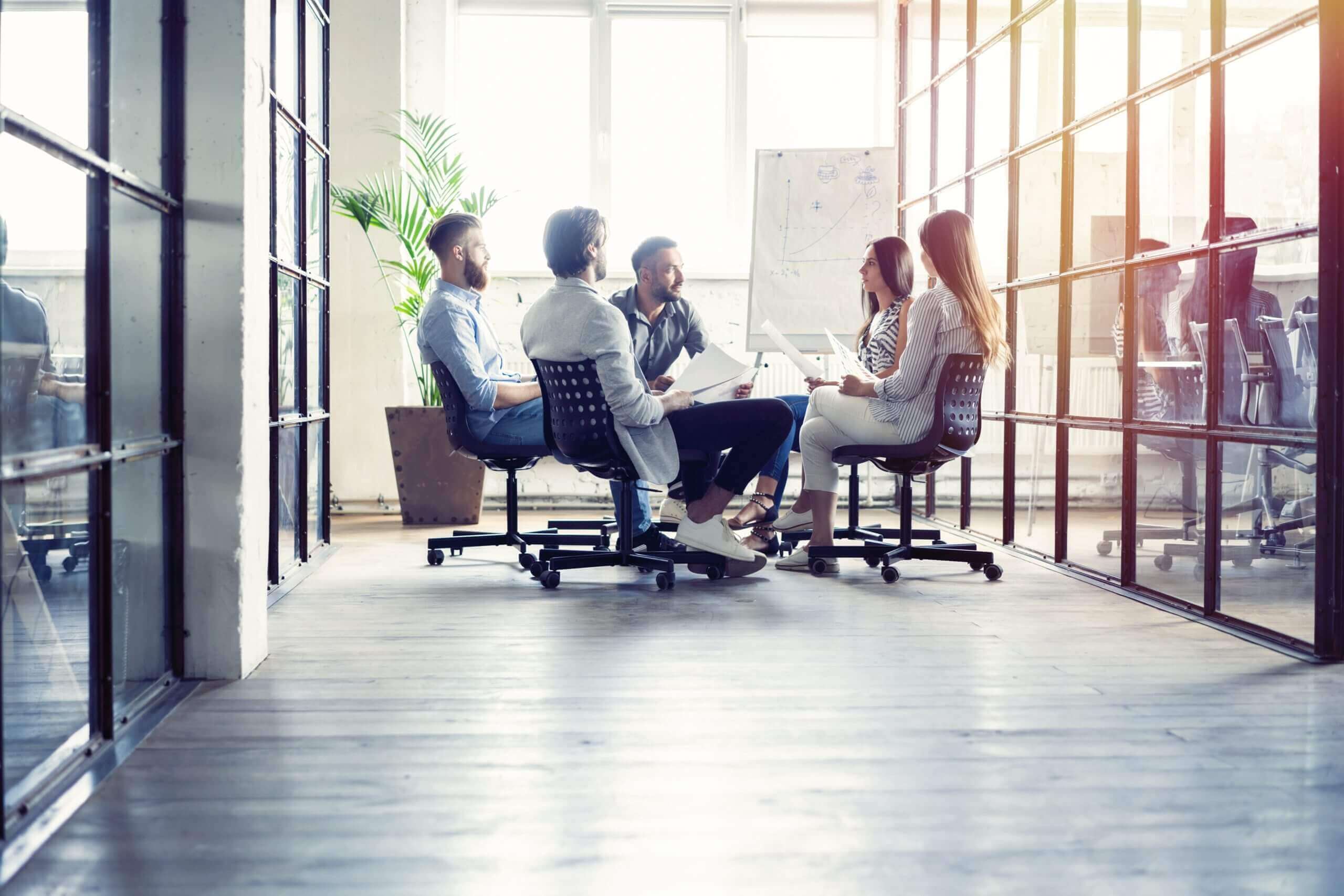  A group of leaders meeting around a whiteboard