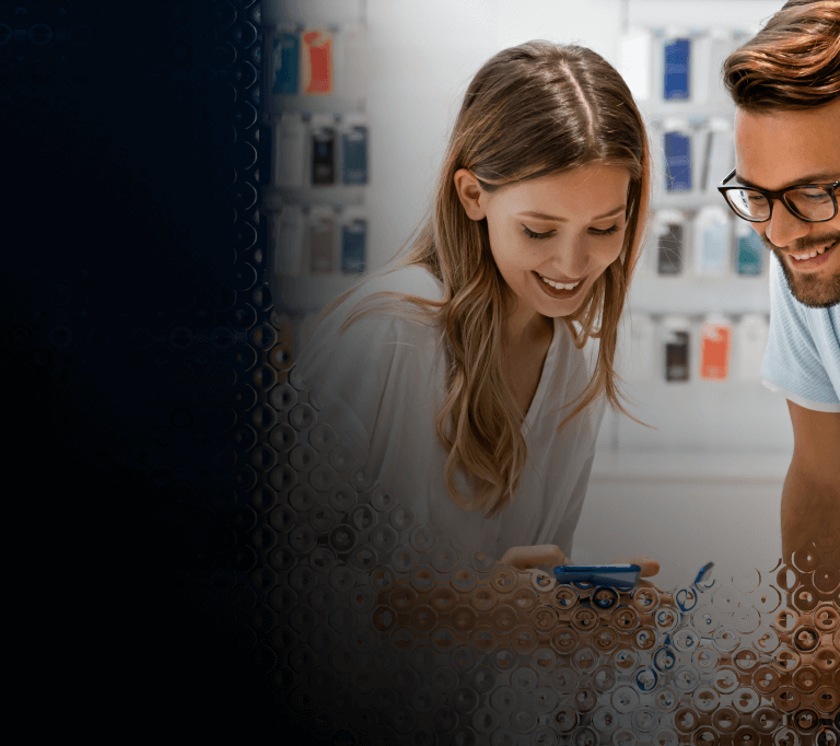 Two people review the features of a mobile device