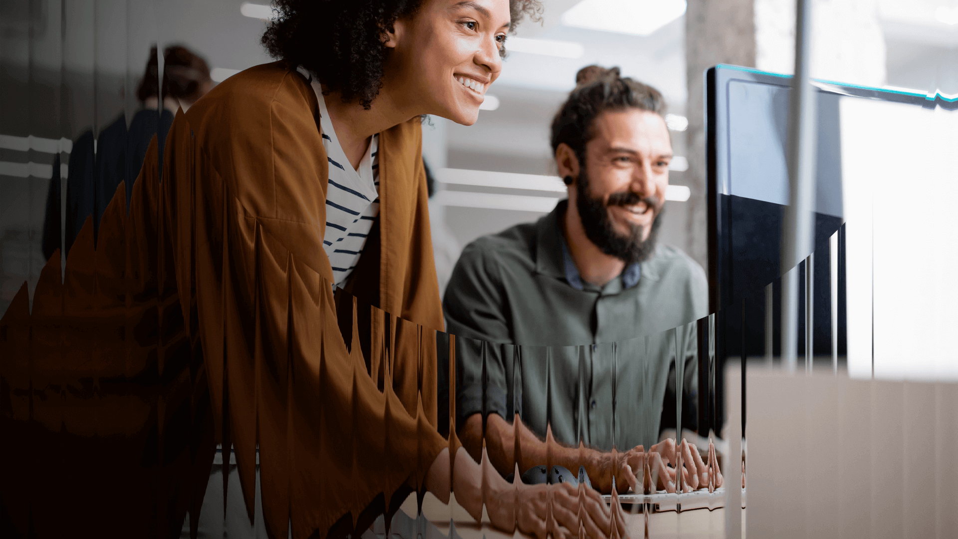 A man at a woman collaborating at a work station