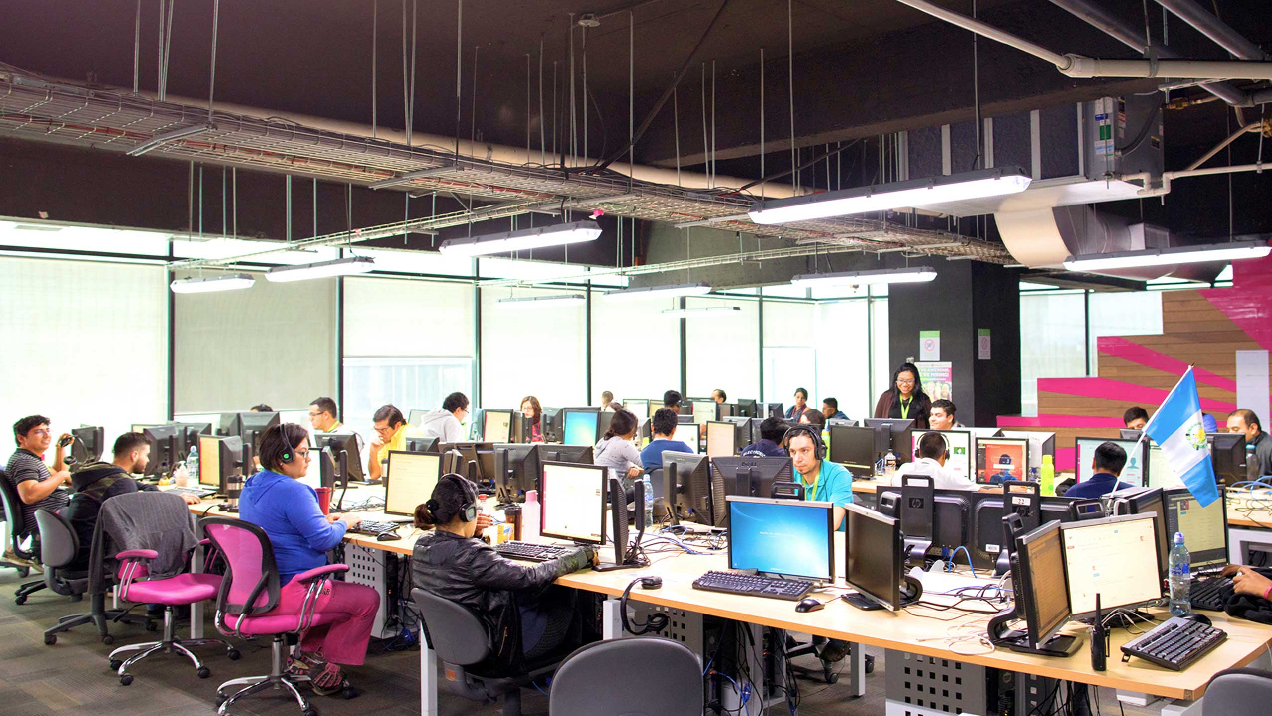 Photo of agents working at the IntouchCX campus in Guatemala City