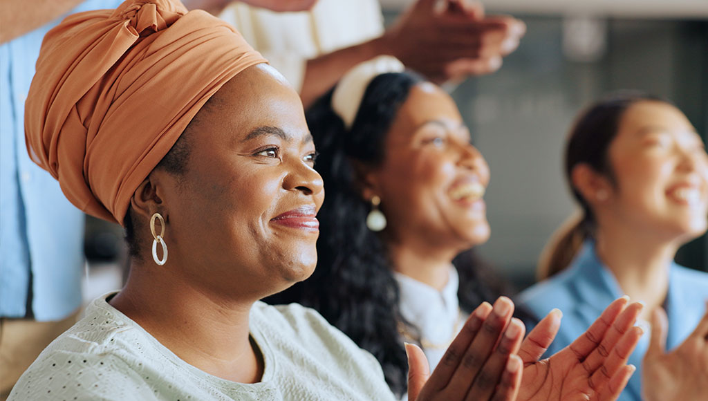 Smiling woman while clapping