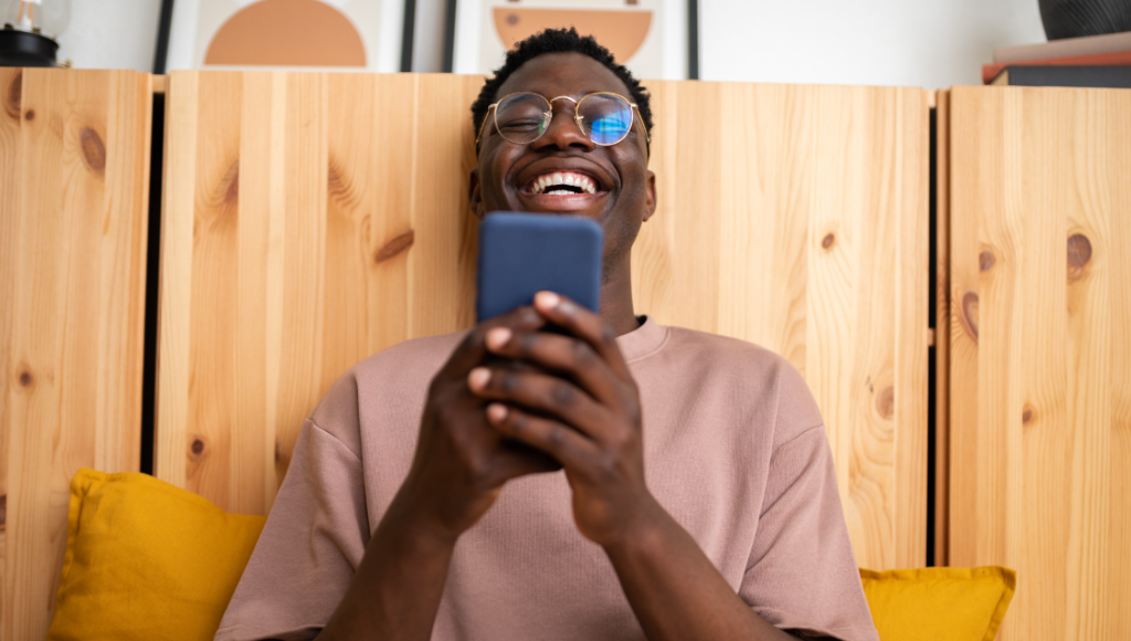 Happy man using his phone