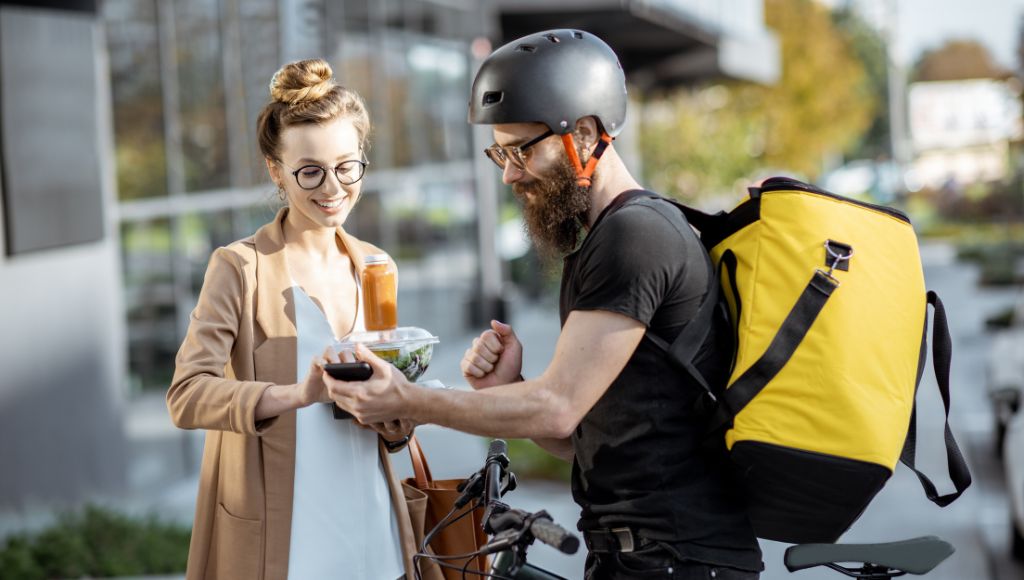 Woman paying her food delivery man