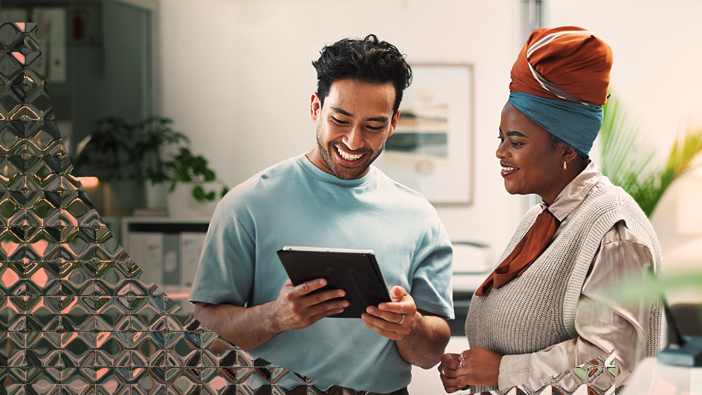 Image of two colleagues talking over a tablet