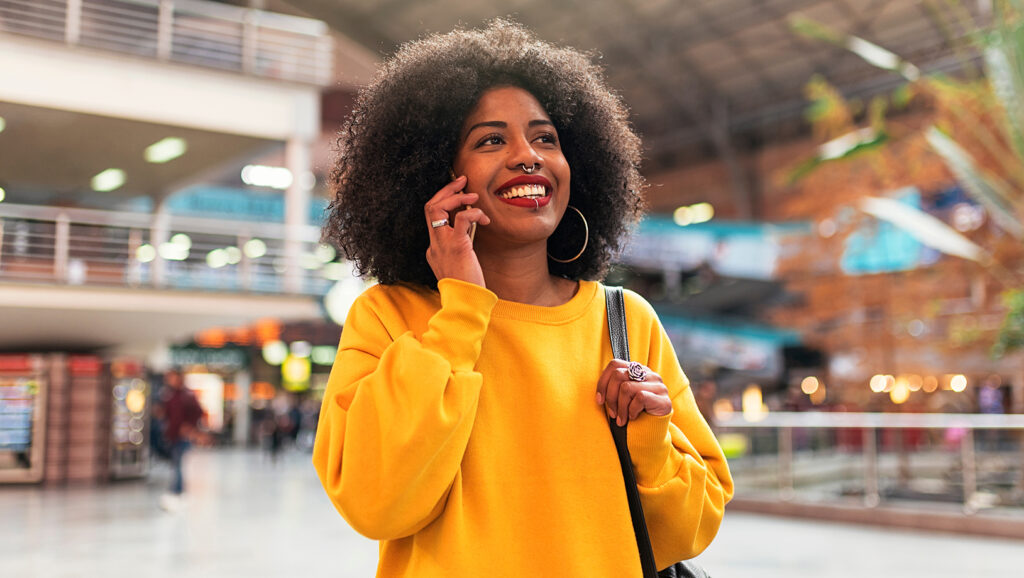 Woman talking on the phone at an airport